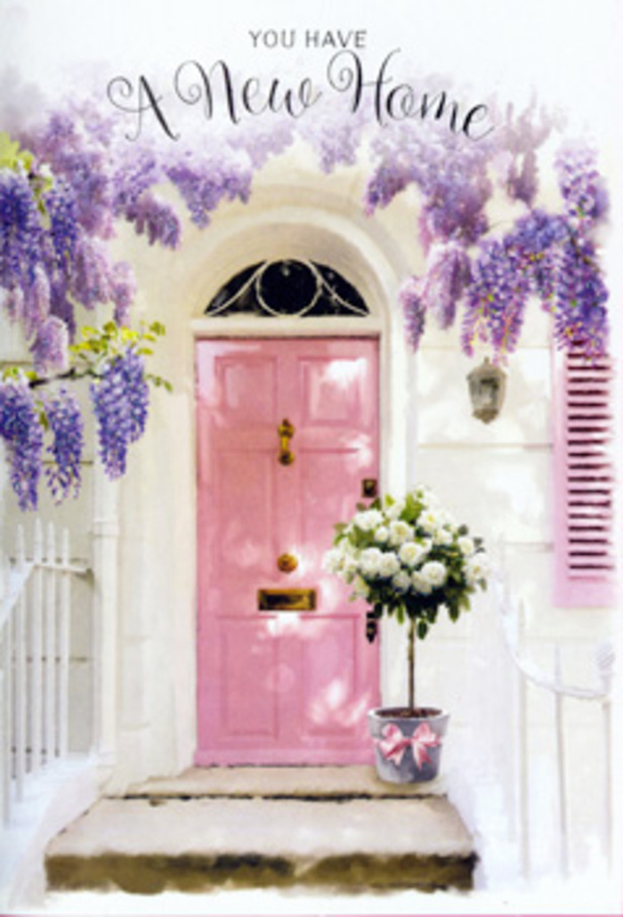 In this image, the entrance to a Surbiton home becomes a poetic tribute to new beginnings. A pale pink front door is the central feature, its panels cleanly defined yet softened by the pastel paint that glows warmly in the light. The door sits within whitewashed walls that bounce brightness back onto the woodwork, while a nearby shutter painted in a complementary blush shade adds balance and charm. Stretching overhead and down the sides of the door, long trails of wisteria cascade in shifting tones of lavender and light purple. Each drooping cluster is composed of many small blossoms, forming luxurious, textured strands that mimic the look of delicate fabric. The wisteria partially veils the doorway, creating a sense of privacy and intimacy, like a floral curtain you might pass beneath when stepping into a quiet house near Claremont Gardens or the tree-lined avenues off Kingston Road. Anchoring the scene at the threshold, a grey metal bucket holds a generous bouquet of creamy white roses, their petals lush and fully open. Nestled among the roses are sprigs of fresh green foliage that lend movement and a touch of wildness, as if just gathered from a well-tended garden. Around the bucket's base, a soft pink satin ribbon is tied, its sheen catching the light and its colour harmonising beautifully with the door above. The bucket sits on a stone step that shows faint textures and shadows, gently dappled by the wisteria overhead. The ambiance is calm yet celebratory, perfectly suited to a housewarming or new home gift for someone settling into life in Surbiton. You can almost hear the quiet of the residential street, feel the cool stone underfoot, and sense the reassuring presence of flowers welcoming you into this fresh chapter.